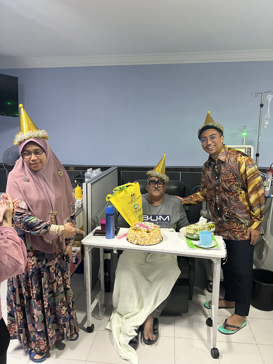 A patient celebrating with family and staff